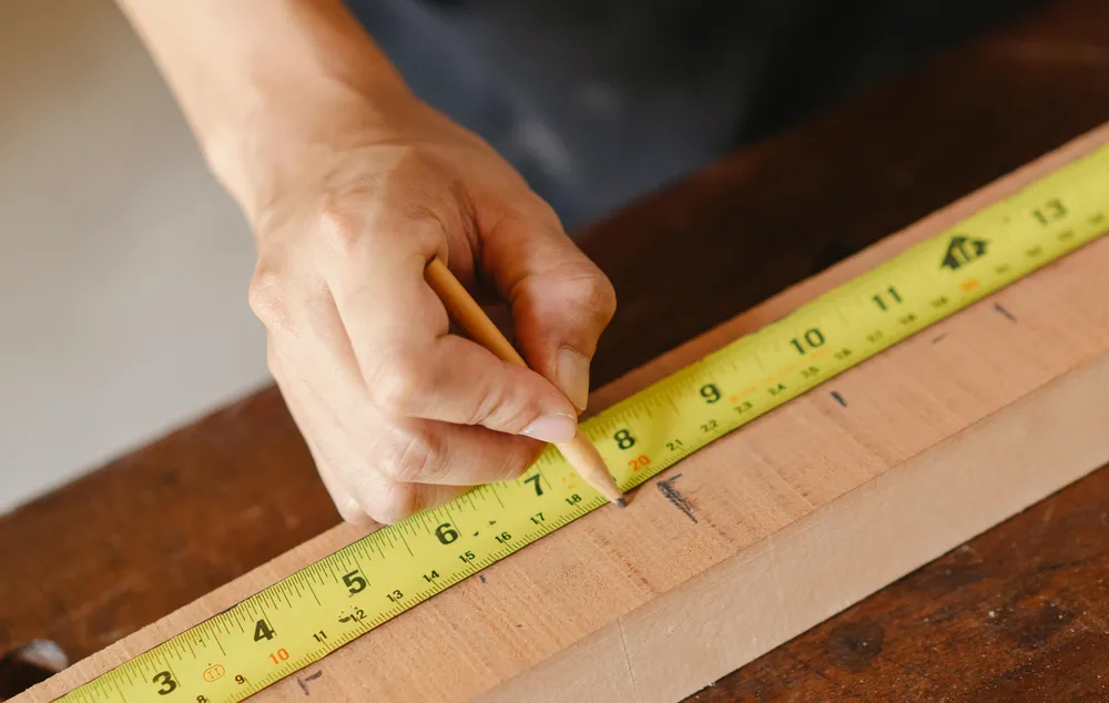 Photo of a carpenter marking and planning a project